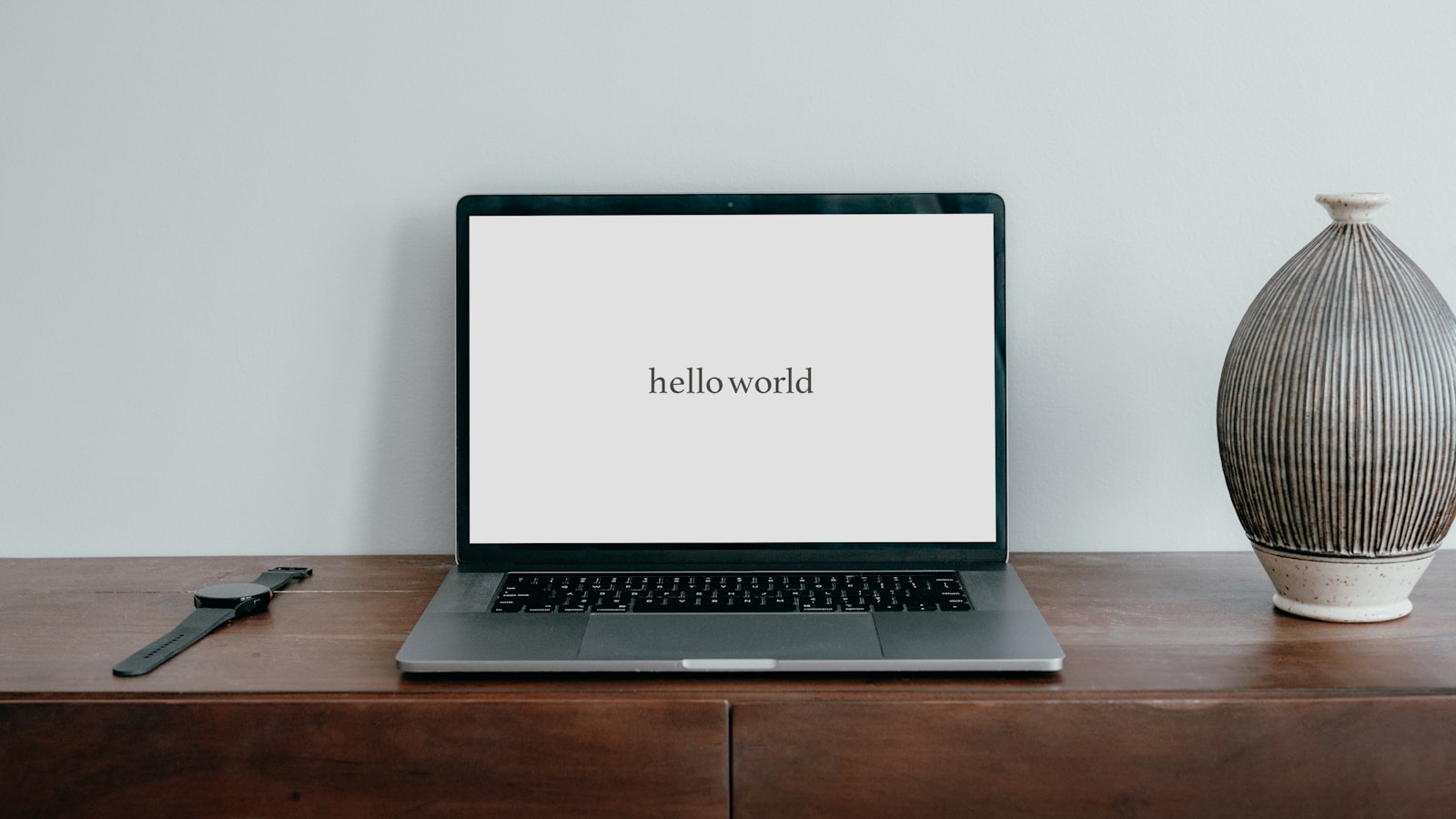 A laptop computer sitting on top of a wooden desk